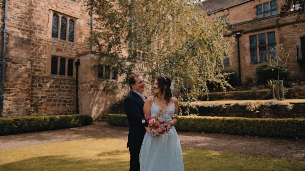 Couple shot in the castle grounds by Durham castle wedding videographer