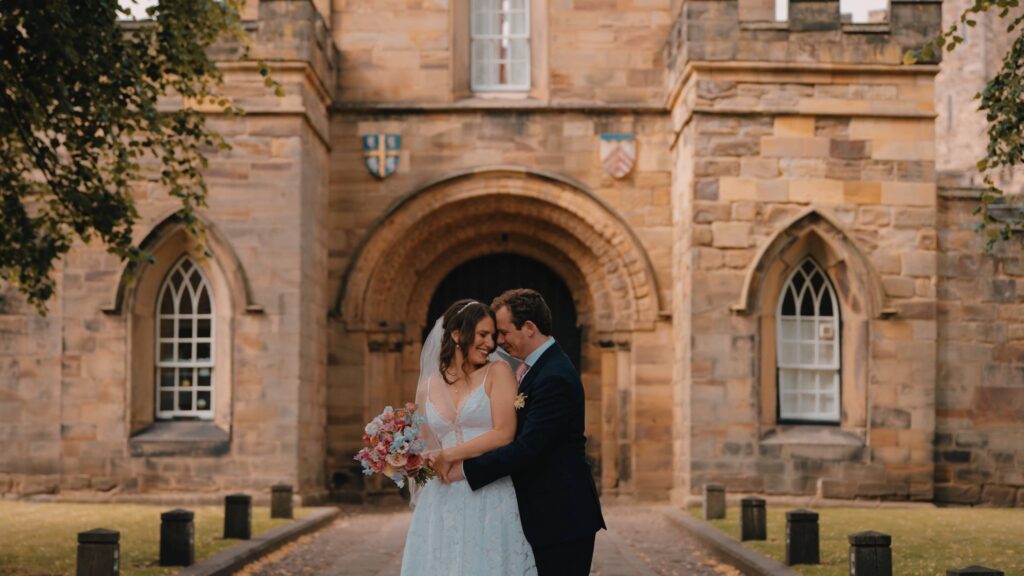 Bride and groom by Durham castle wedding videographer