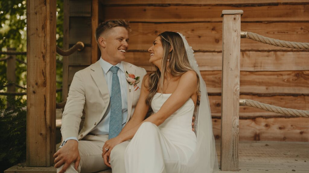 bride and groom laughing by millbridge court wedding videographer